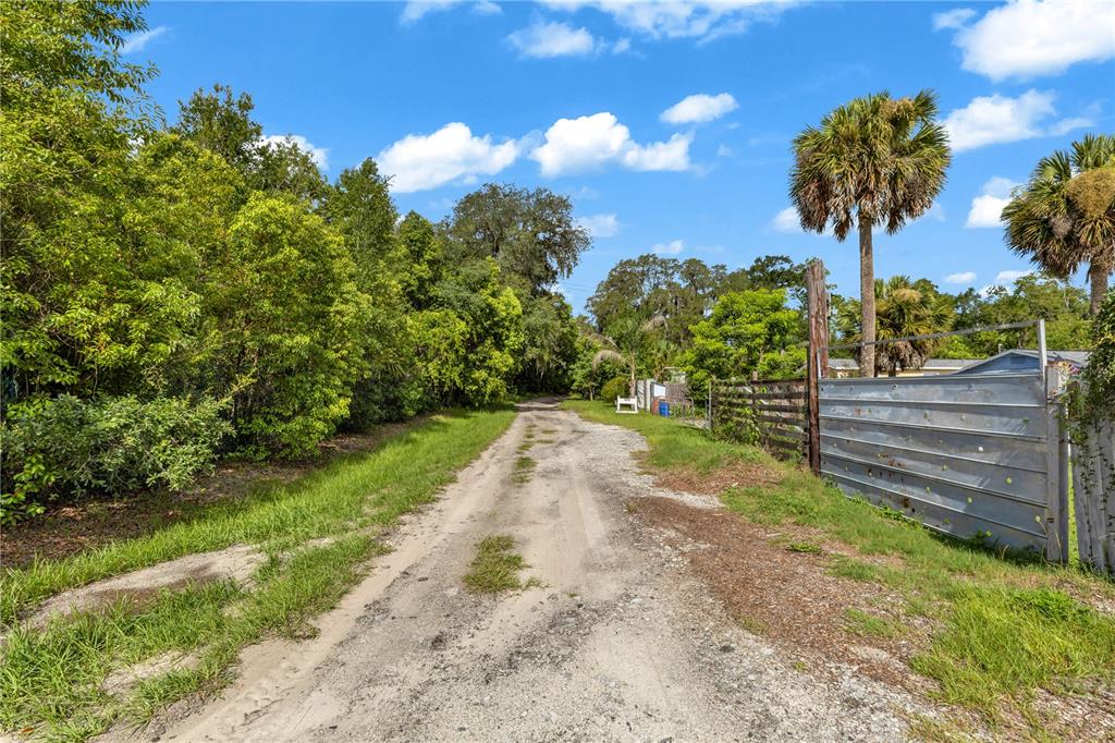 An aerial view shows a large residential lot with multiple buildings, trees, and parked vehicles — 405 W SIMON AVENUE, APOPKA, FL