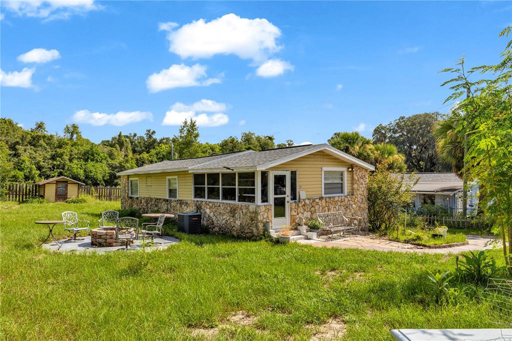 An aerial view shows multiple houses, outbuildings, and vehicles on a large, tree-lined rural lot — 405 W SIMON AVENUE, APOPKA, FL