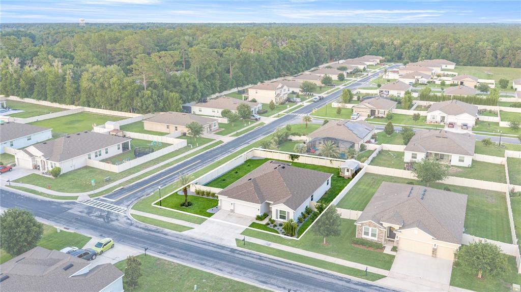 An aerial view shows a suburban neighborhood with single-family homes and fenced backyards — 1927 NE 50TH COURT, OCALA, FL