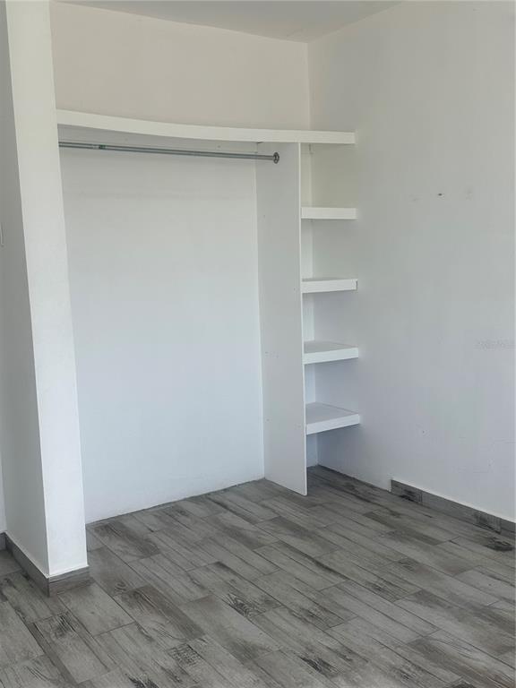 An interior view of a closet area with white shelving and a metal hanging rod — Calle 12 2874 CALLE 12, RINCON, PR