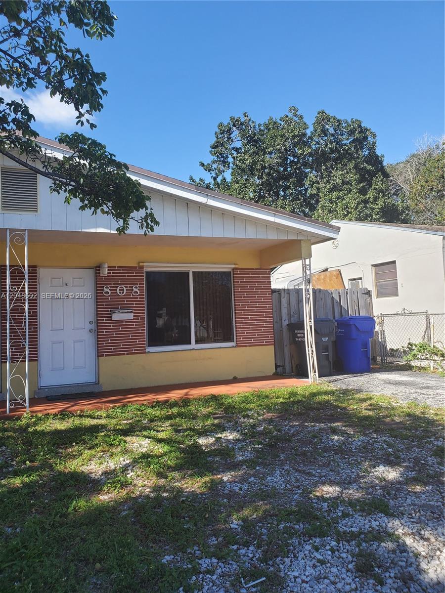 A single-story house with a brick facade, white door, and a gravel front yard — 808 N 24th Ave # 1, Hollywood FL 33020, HOLLYWOOD, FL