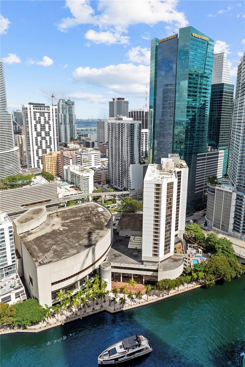 An aerial view of a Miami waterfront cityscape featuring high-rise buildings and a yacht — 31 SE 5th St # 4018, Miami FL 33131, MIAMI, FL