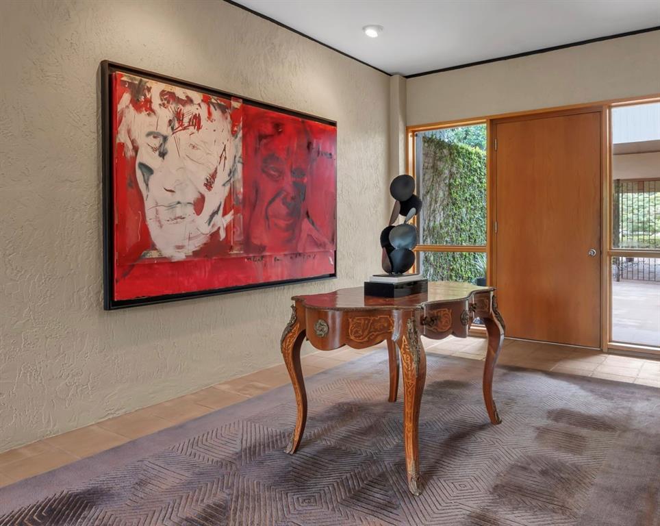 An entryway features a large red abstract painting, an ornate wooden table, and a rug — 111 SAND PINE LANE, LONGWOOD, FL