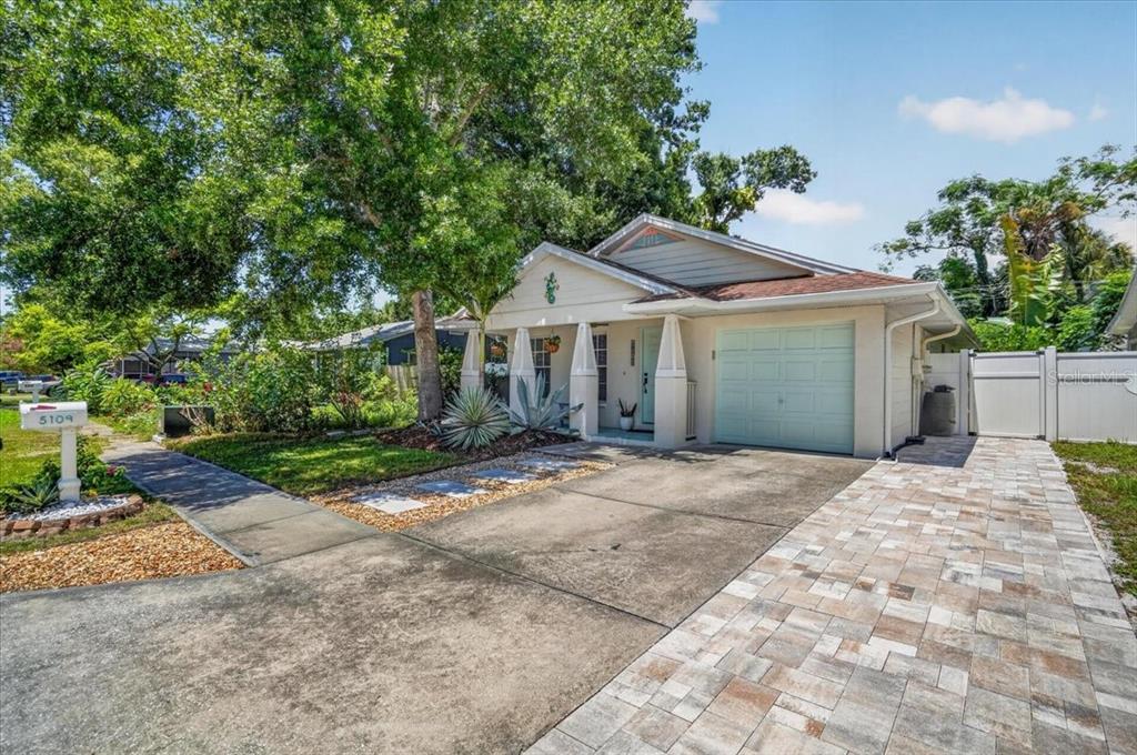 A single-story house with a light-colored exterior, a garage, and a paved driveway — 5109 17TH AVENUE S, GULFPORT, FL