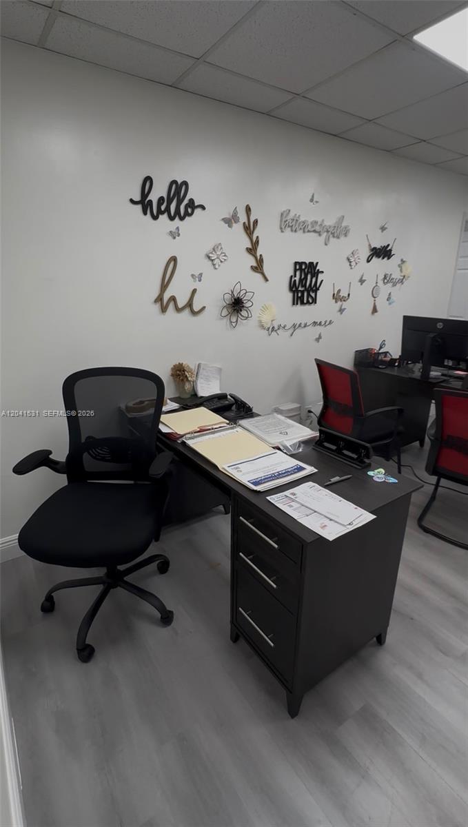An office space features two desks, black mesh chairs, and wall-mounted decorative lettering and butterflies — 175 Fontainebleau Blvd, Miami FL 33172, MIAMI, FL