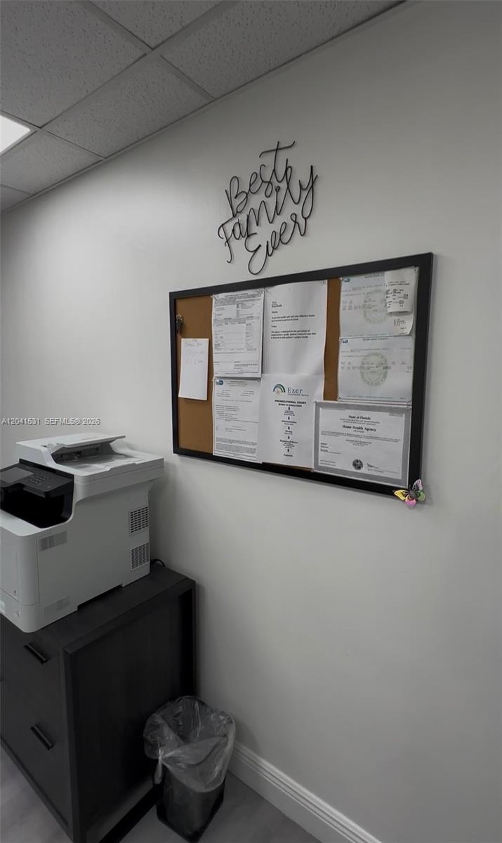 A printer sits on a black cabinet next to a bulletin board on a wall — 175 Fontainebleau Blvd, Miami FL 33172, MIAMI, FL