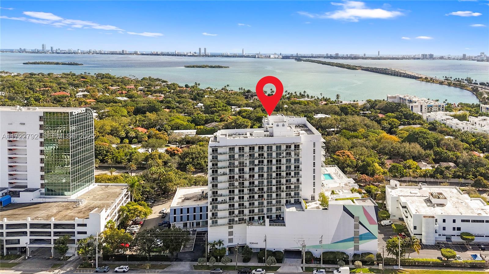 An aerial view shows a multi-story white apartment building with a red location pin — 4250 Biscayne Blvd # 1418, Miami FL 33137, MIAMI, FL