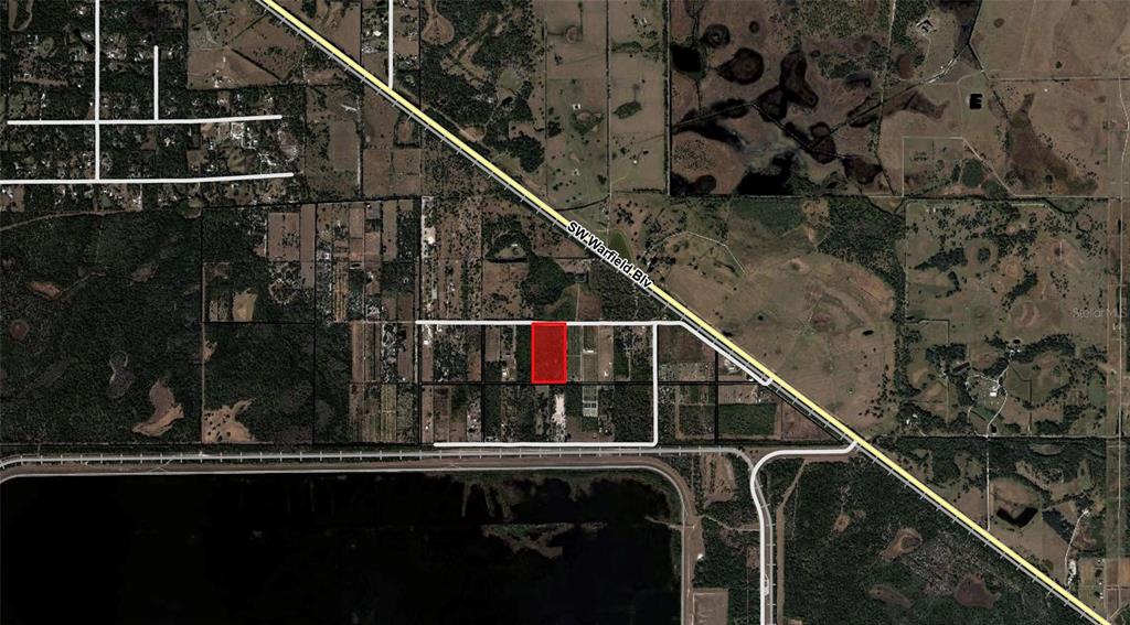 An aerial map shows a rectangular red-highlighted property parcel located near a major road — SW ARROWROOT STREET, INDIANTOWN, FL