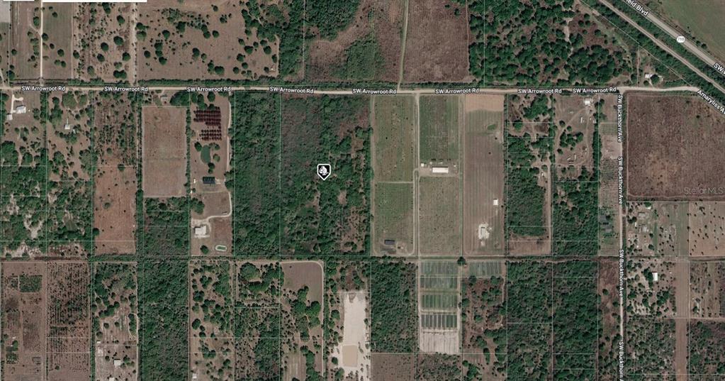 This is an aerial map view of a wooded parcel of land — SW ARROWROOT STREET, INDIANTOWN, FL