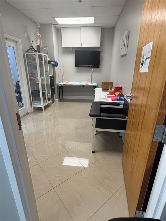 A medical phlebotomy room features a phlebotomy chair, a supply cabinet, and a training table — 12701 S JOHN YOUNG PARKWAY UNIT 212, ORLANDO, FL