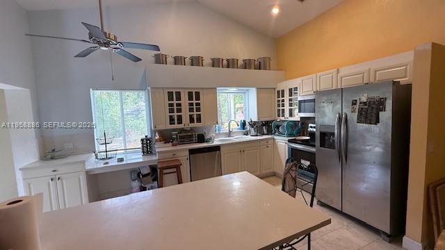 A kitchen with white cabinets, stainless steel appliances, a ceiling fan, and a center island — 4465 SW 38th Ter, Dania Beach FL 33312, DANIA BEACH, FL