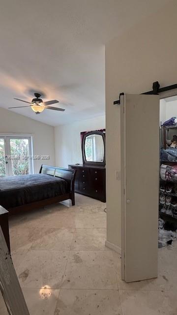 A bedroom with a dark wood bed, matching dresser, tile floors, and a sliding closet door — 4465 SW 38th Ter, Dania Beach FL 33312, DANIA BEACH, FL