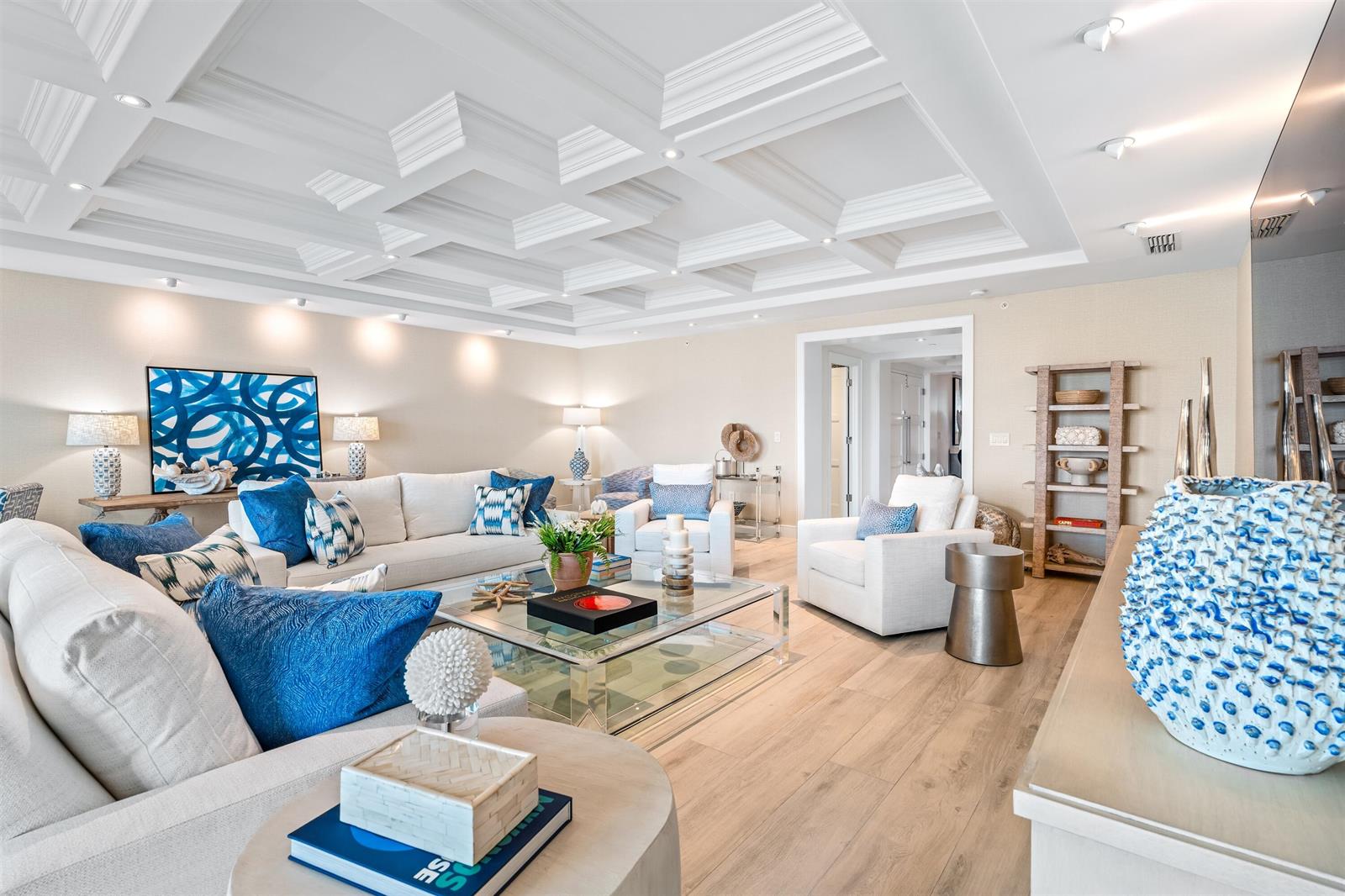 A bright living room features a coffered ceiling, light wood flooring, and blue accent pillows — 500 SE 5th Avenue # s, Boca Raton FL 33432, BOCA RATON, FL