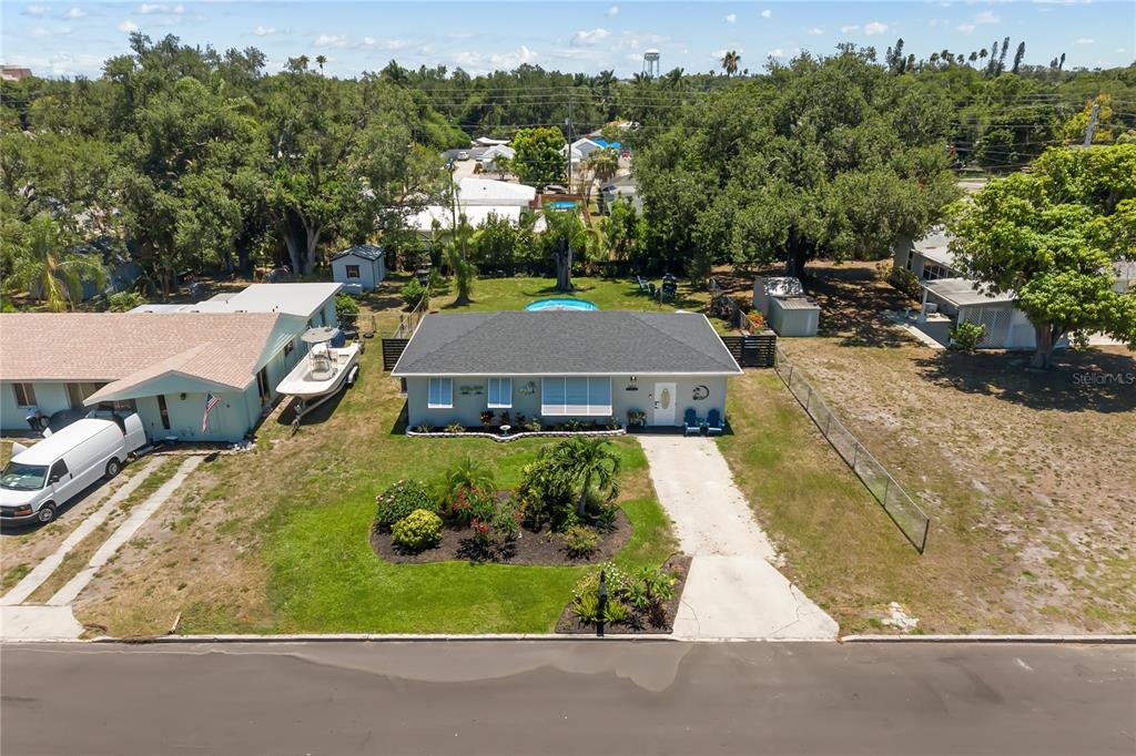 An aerial view of a single-story house with a gray roof, pool, and driveway — 1611 27TH STREET W, BRADENTON, FL