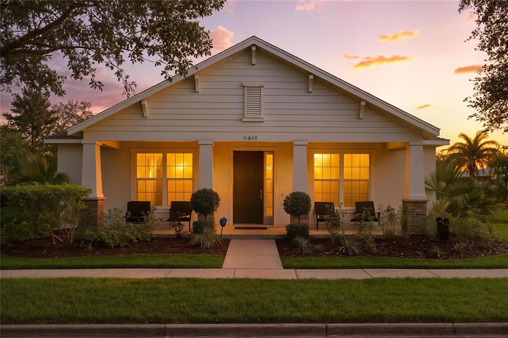 A single-story house with a covered front porch, stone-based columns, and a paved walkway — 2560 GRASMERE VIEW PARKWAY S, KISSIMMEE, FL