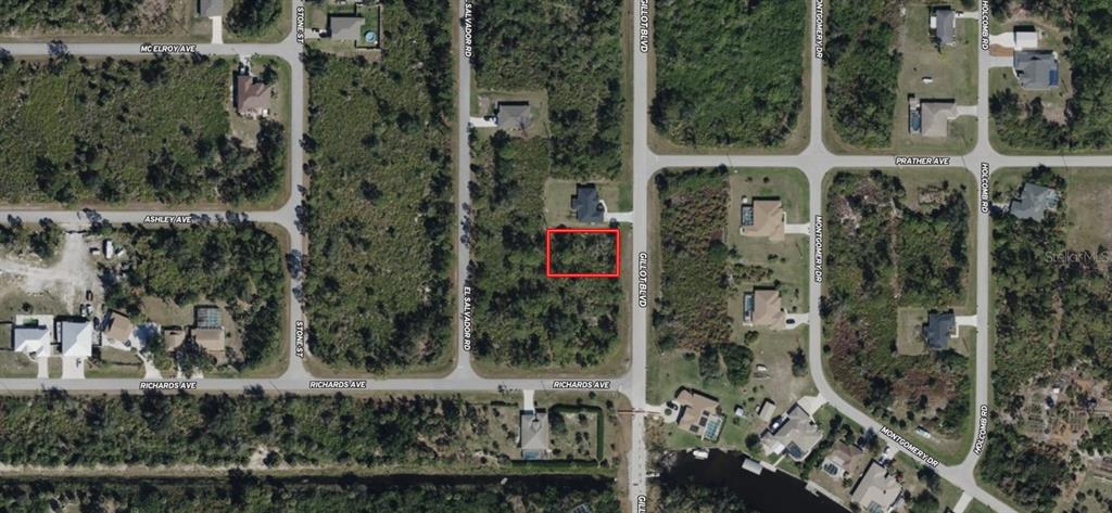 This aerial map shows a vacant rectangular lot outlined in red along a paved road — 3401 GILLOT BOULEVARD, PORT CHARLOTTE, FL
