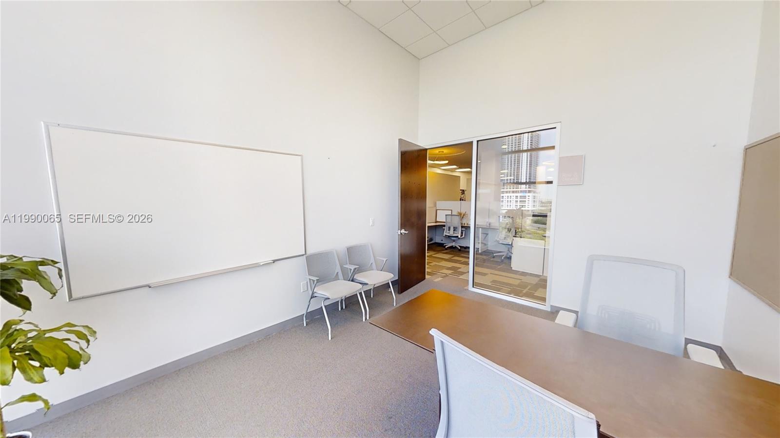 An office room features a desk, two guest chairs, a whiteboard, and a glass door — 1501 Biscayne Blvd # 501W, Miami FL 33132, MIAMI, FL