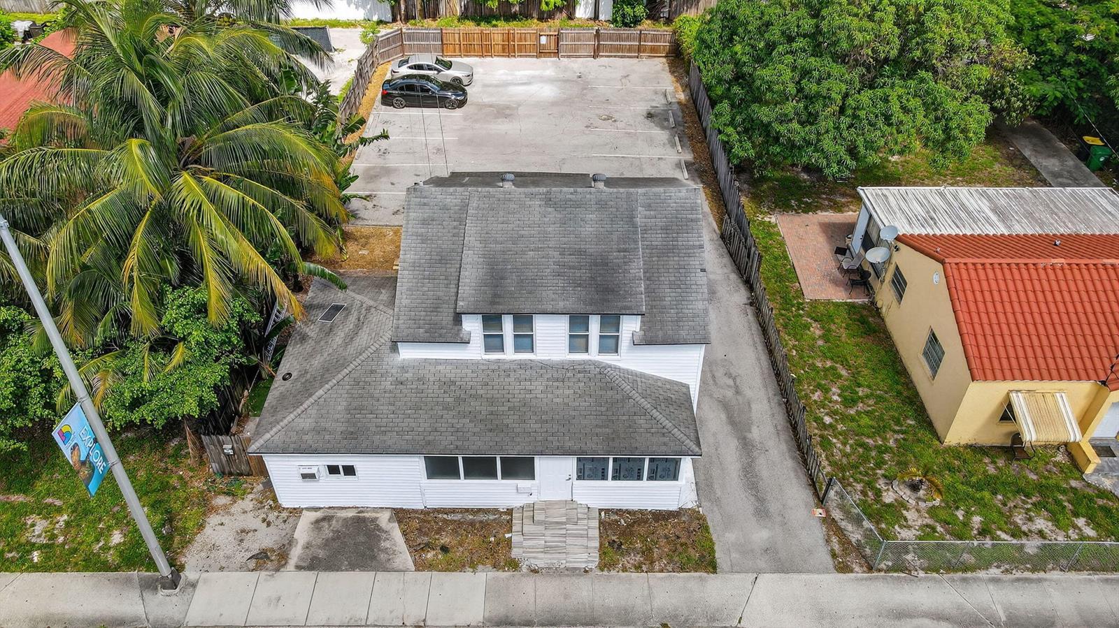 An aerial view shows a white two-story house with a parking lot behind it — 220 SW 16th Street, Dania Beach FL 33004, DANIA BEACH, FL