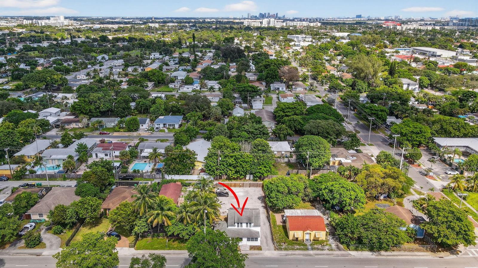 An aerial view shows a white house with a gray roof marked by a red arrow — 220 SW 16th Street, Dania Beach FL 33004, DANIA BEACH, FL