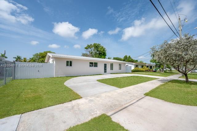 A single-story house with a white exterior, a concrete driveway, and a white fence — 10040 SW 215th St, Cutler Bay FL 33189, CUTLER BAY, FL