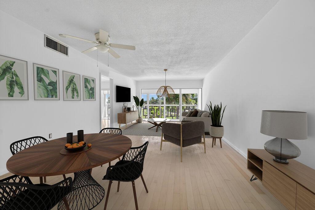 This is a rendering of an open-concept living and dining area with light wood floors — 331 Tequesta Drive # 224, Tequesta FL 33469, TEQUESTA, FL