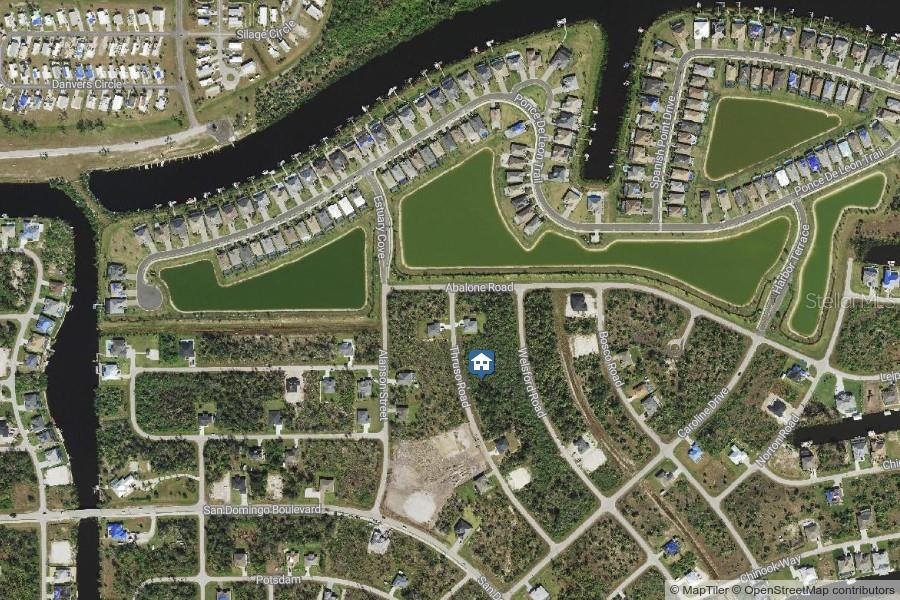 This is an aerial map view of a residential neighborhood with houses, streets, and ponds — 8078 THRUSO ROAD, PORT CHARLOTTE, FL