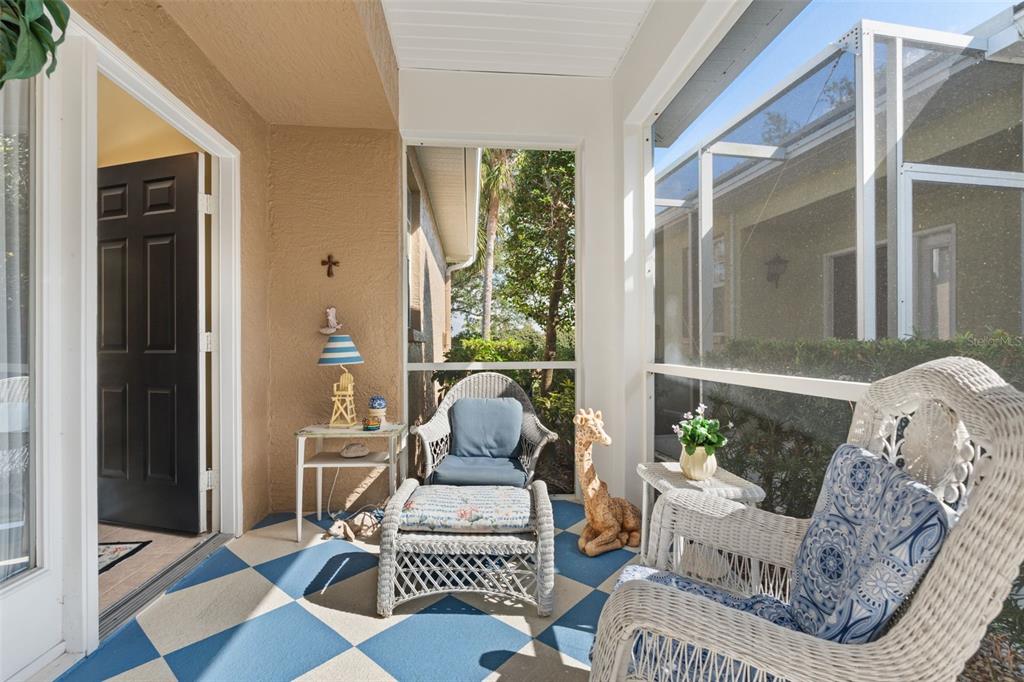 A kitchen features white cabinets, white appliances, tan countertops, and tile flooring — 905 BARCLAY COURT, VENICE, FL