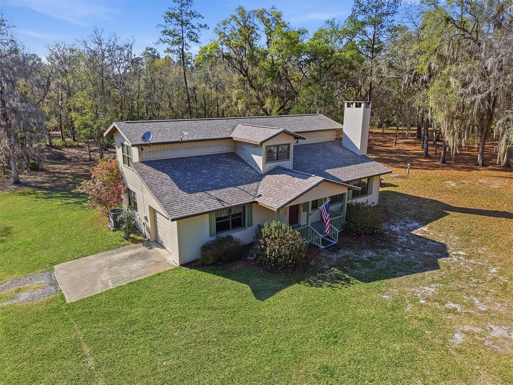 An aerial view of a two-story house with a shingled roof and a front porch — 14600 NW 216TH PLACE, MICANOPY, FL