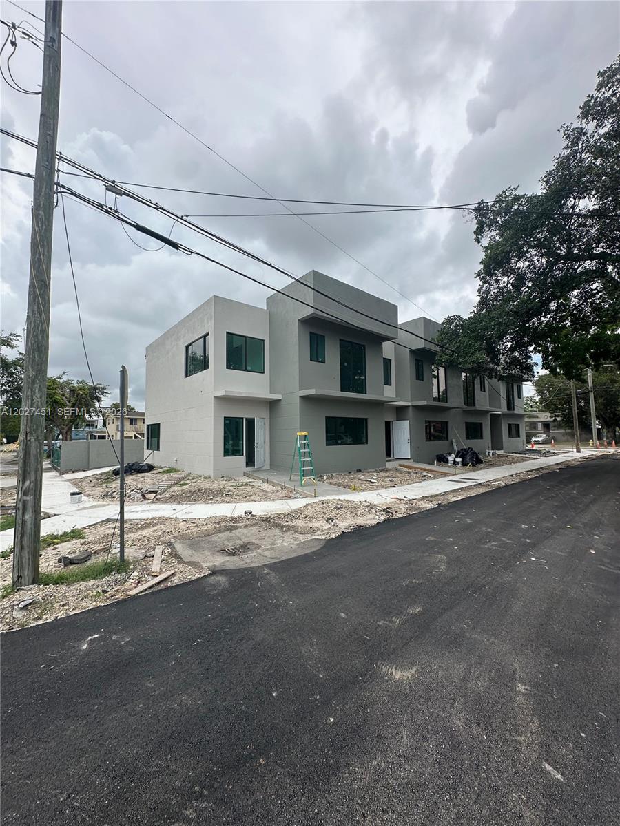 A newly constructed multi-unit residential building with gray stucco siding stands along a paved street — 6480 NE 1st Ave # 6480, Miami FL 33150, MIAMI, FL