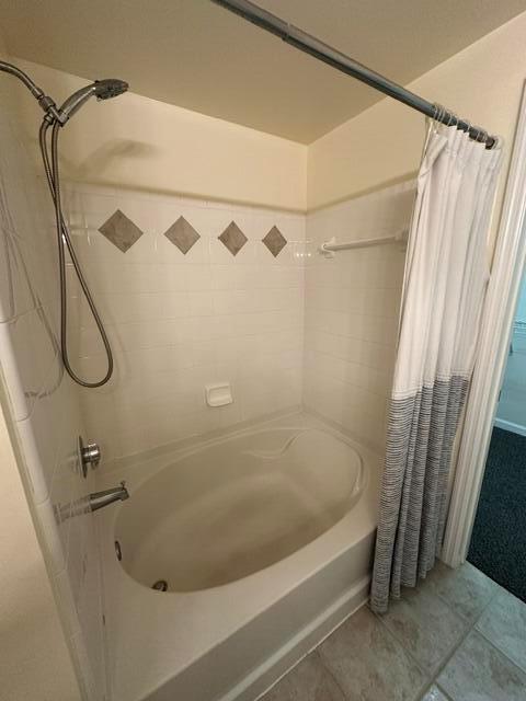 A white bathtub with a handheld showerhead and a decorative tile accent wall — 2036 Alta Meadows Lane # 1403, Delray Beach FL 33444, DELRAY BEACH, FL