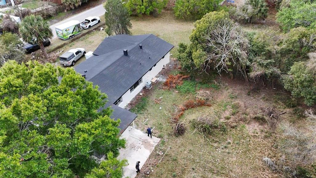 An aerial view shows a house with a dark roof, surrounding trees, and parked vehicles — 4217 WD JUDGE DRIVE UNIT W, ORLANDO, FL