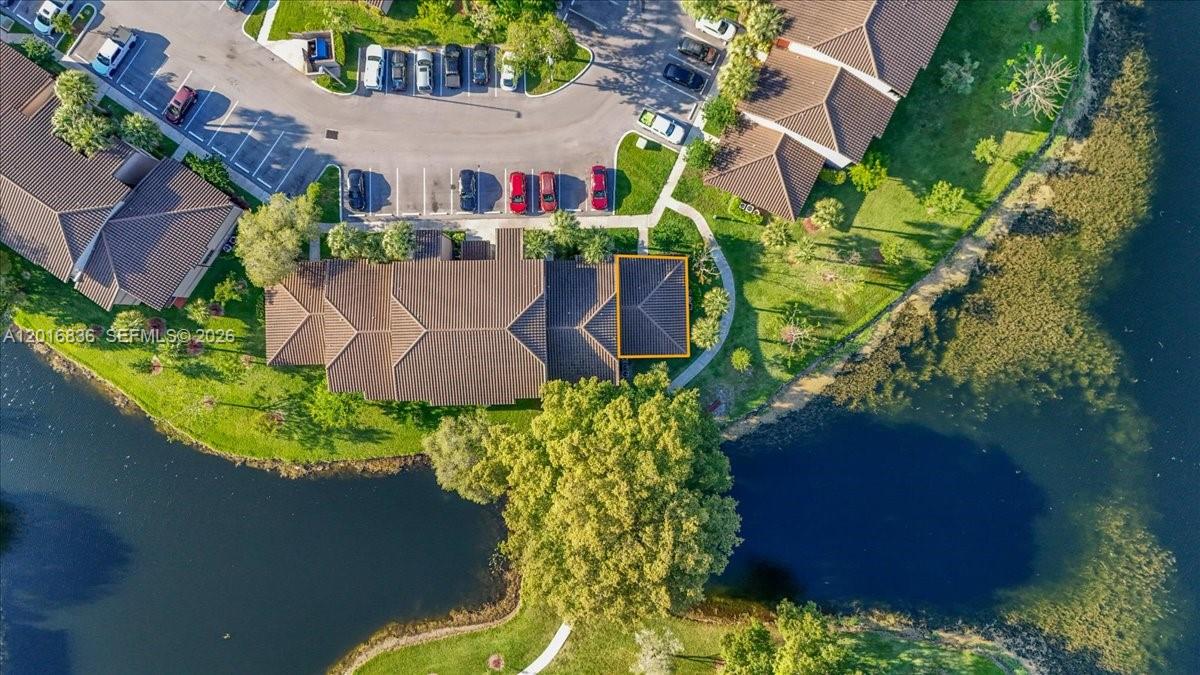 An aerial view shows a residential building with a highlighted roof section near a lake — 9860 Nob Hill Ln # 9860, Sunrise FL 33351, SUNRISE, FL