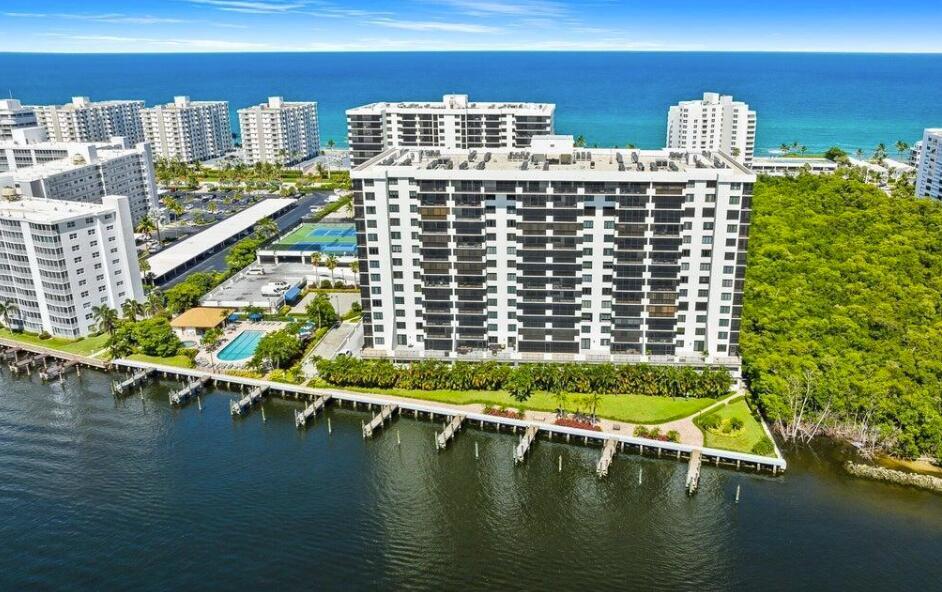 An aerial view of a waterfront apartment complex with a pool and boat docks — 3420 S Ocean Boulevard # 8t, Highland Beach FL 33487, HIGHLAND BEACH, FL