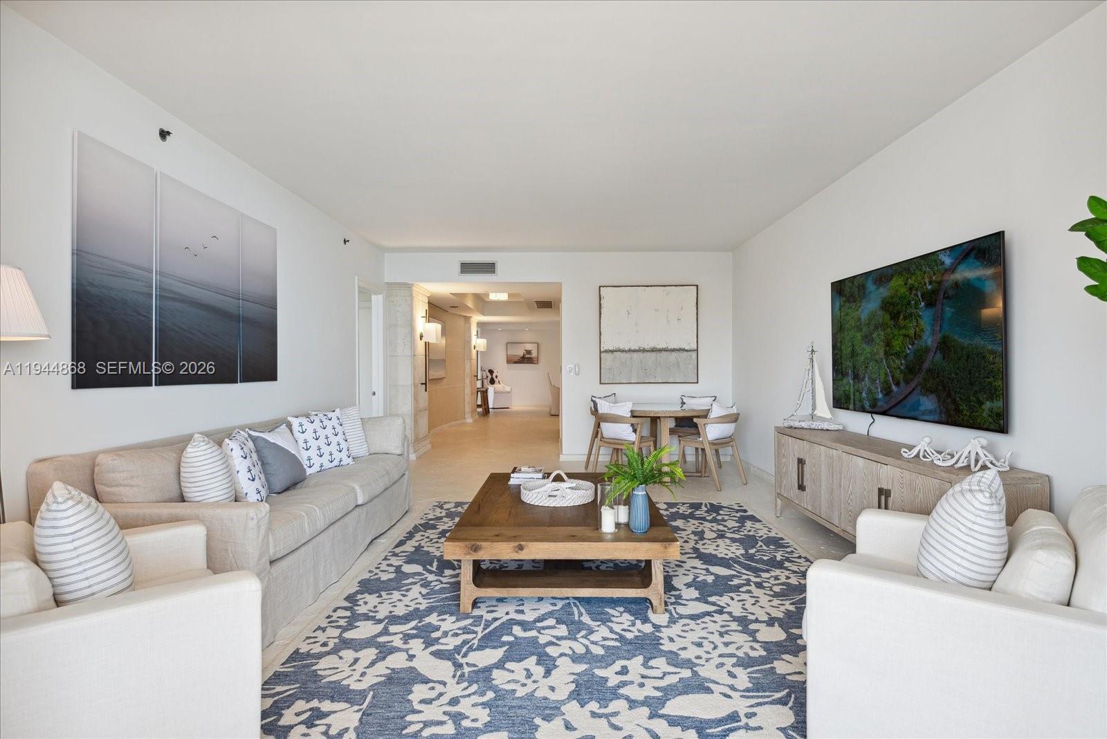 A living room features a beige sofa, two armchairs, a coffee table, and a rug — 791 Crandon Blvd # 1501, Key Biscayne FL 33149, KEY BISCAYNE, FL