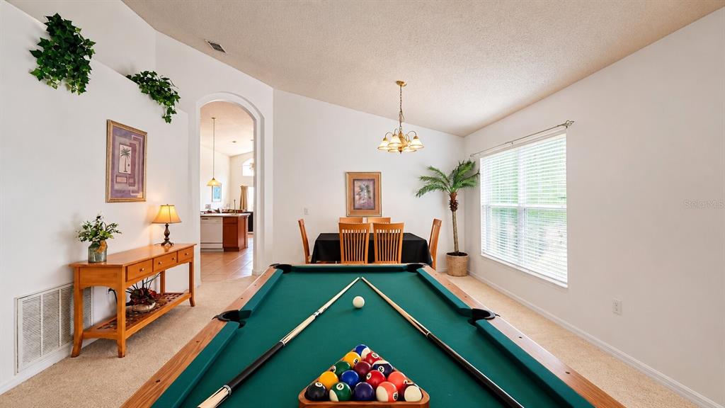 A game room features a pool table, a dining set, and a wooden console table — 1691 WATERVIEW LOOP, HAINES CITY, FL