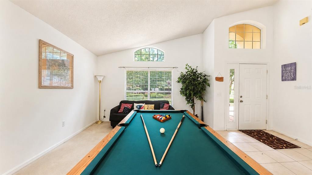 A room with a pool table, a sofa, a floor lamp, and a front entrance — 1691 WATERVIEW LOOP, HAINES CITY, FL