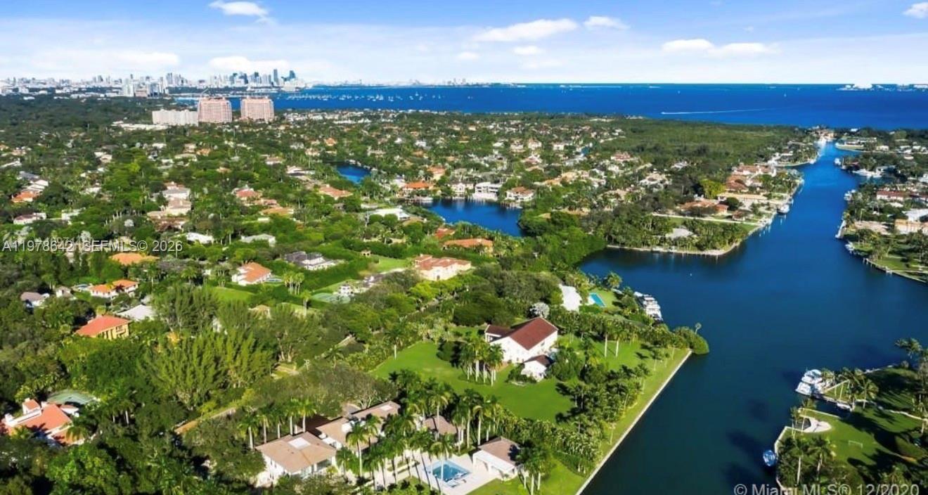 An aerial view of a waterfront residential neighborhood with lush greenery and a canal — 4895 SW 88th St # 00, Miami FL 33156, MIAMI, FL