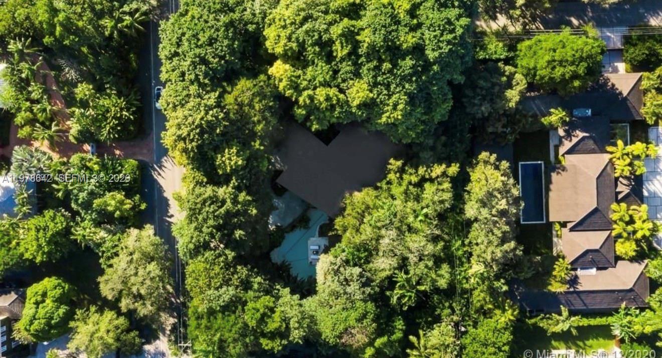 An aerial view shows a house nestled among dense trees with a rectangular swimming pool — 4895 SW 88th St # 00, Miami FL 33156, MIAMI, FL