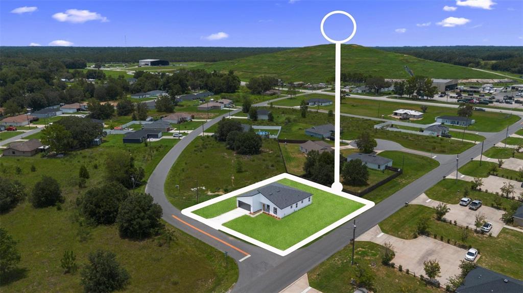 An aerial view shows a single-story house with a white exterior and a gray roof — 55 LAUREL COURSE, OCALA, FL