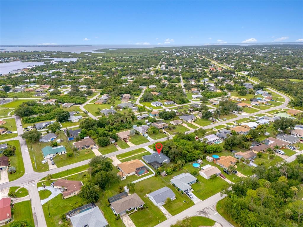 An aerial view shows a residential neighborhood with a red pin marking a specific house — 19836 MIDWAY BOULEVARD, PORT CHARLOTTE, FL
