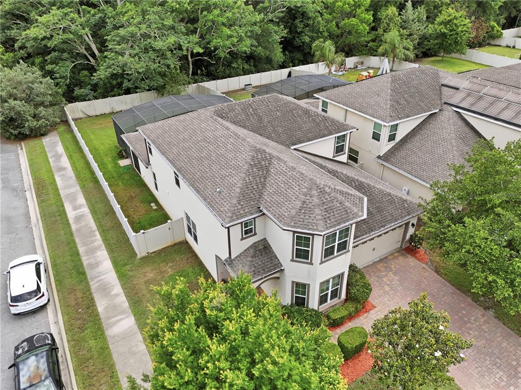 An aerial view shows a two-story house with a shingled roof and a screened patio — 5248 LANDMARK DRIVE, ST CLOUD, FL