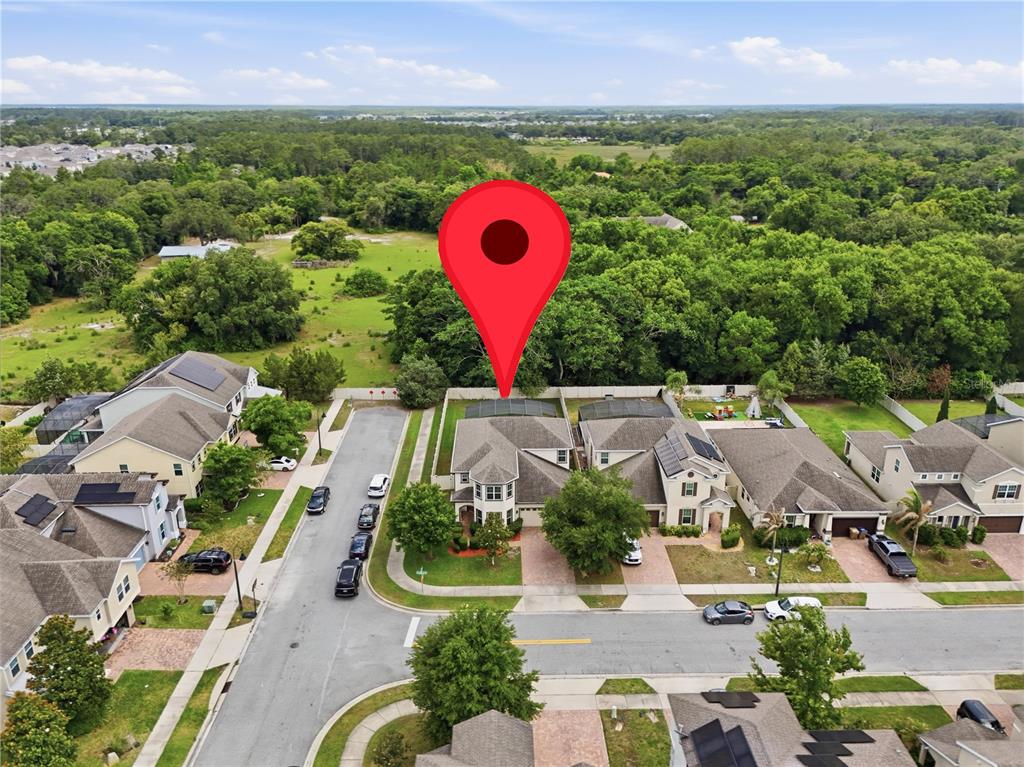 An aerial view shows a suburban neighborhood with a red location pin over a house — 5248 LANDMARK DRIVE, ST CLOUD, FL