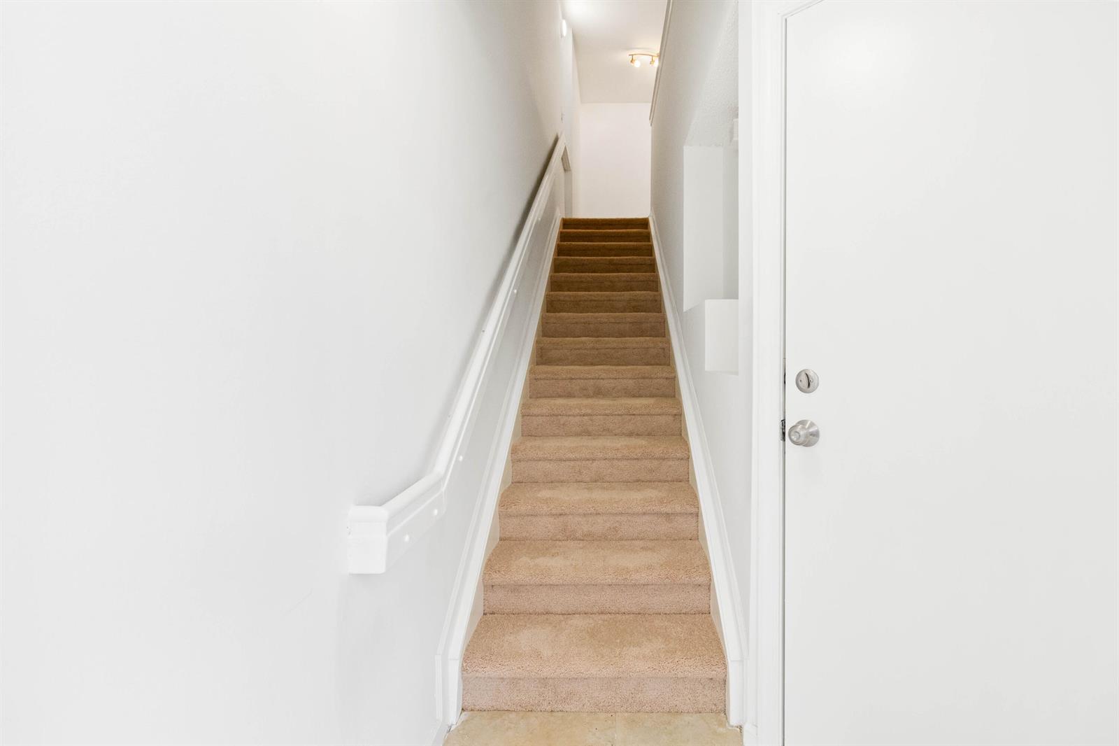 A carpeted staircase leads upward between two white walls with a handrail on the left — 20889 Saint Andrews Boulevard, Boca Raton FL 33433, BOCA RATON, FL