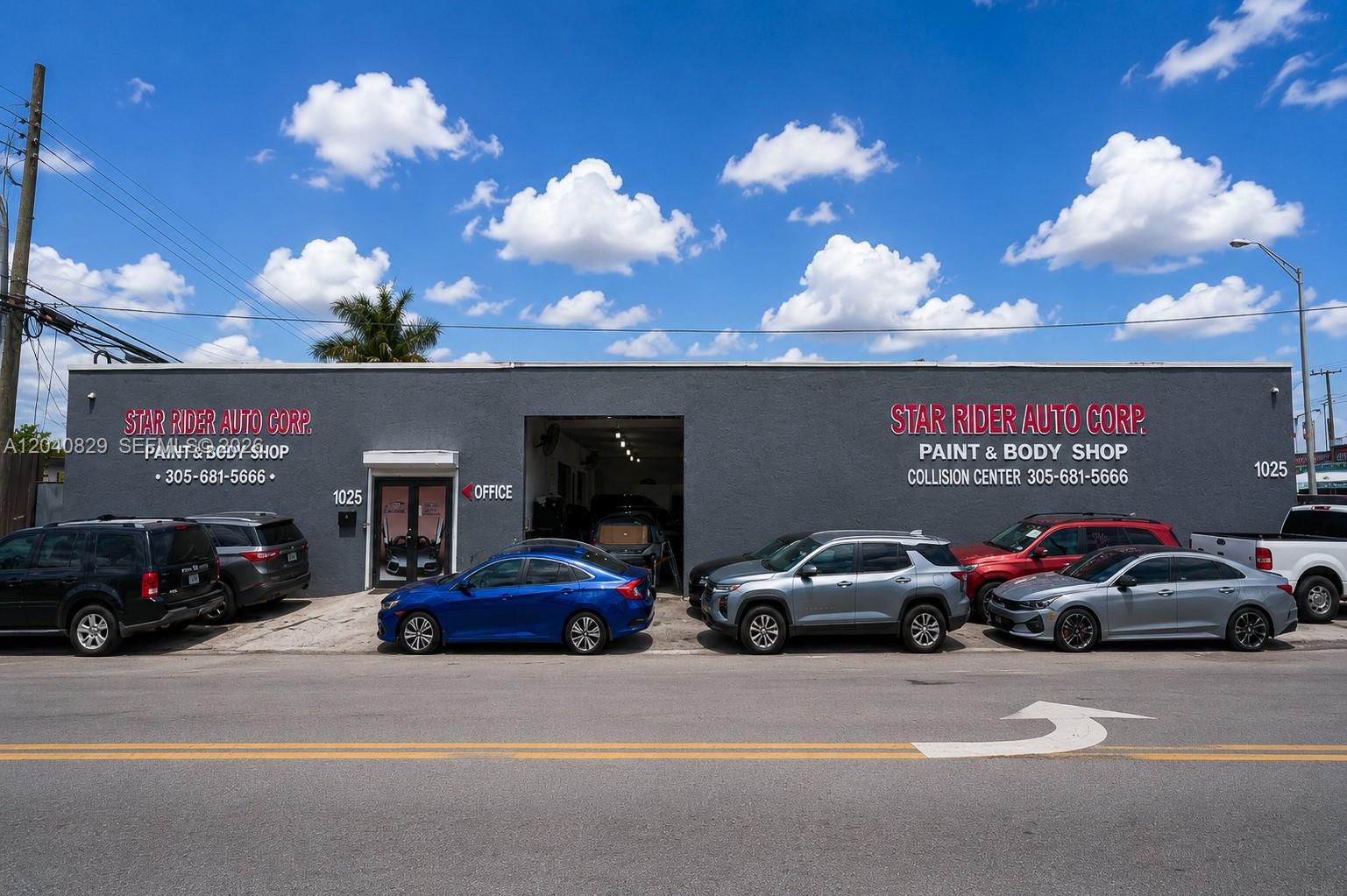 The exterior of a gray commercial auto body shop building with several parked cars — 1025 E 45th St, Hialeah FL 33013, HIALEAH, FL