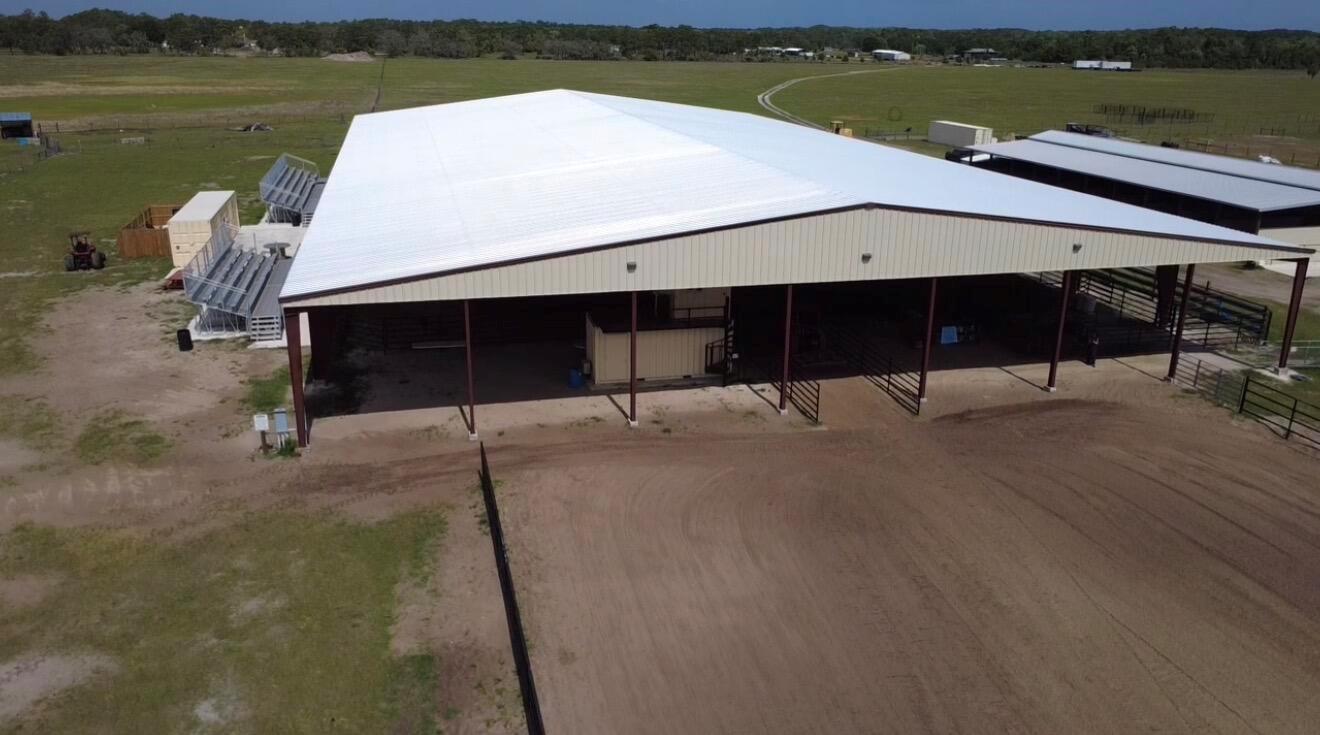 An aerial view of an open-air metal arena with bleachers and a dirt riding surface — 33700 Hwy 441, Okeechobee FL 34972, OKEECHOBEE, FL