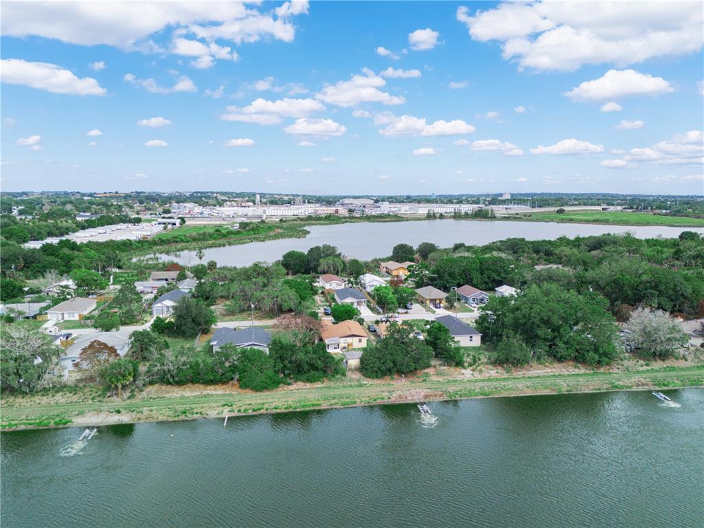 An aerial view shows a residential neighborhood situated between two bodies of water — 129 W NORTHSIDE DRIVE, LAKE WALES, FL