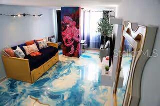 A living room features a daybed, a vibrant octopus mural, and a blue marbled floor — 1126 ASHFORD UNIT 27, SAN JUAN, PR