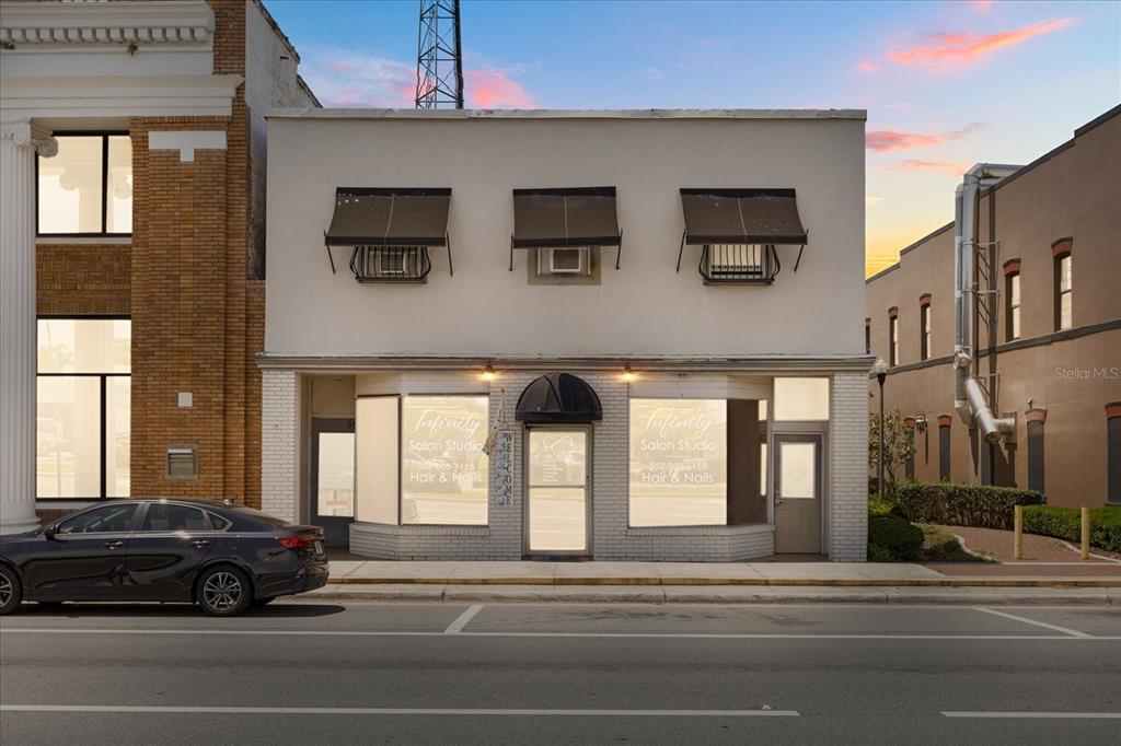 A two-story commercial building with a salon storefront on the ground level — 61 N CENTRAL AVENUE, UMATILLA, FL
