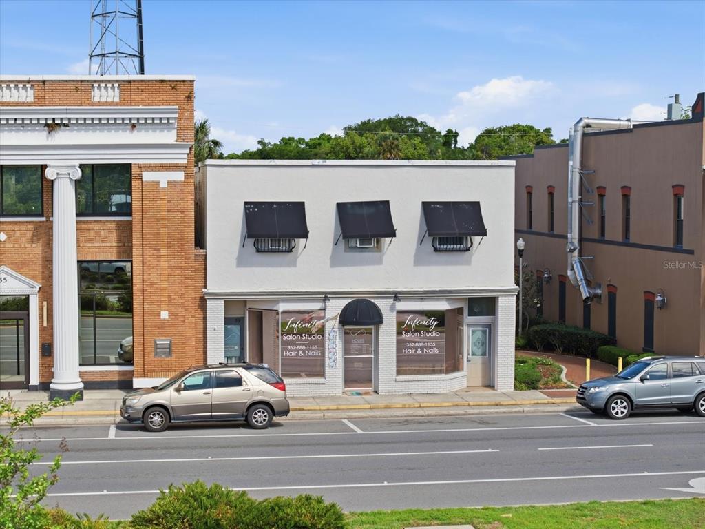 A two-story commercial building with a salon on the ground floor and street parking — 61 N CENTRAL AVENUE, UMATILLA, FL
