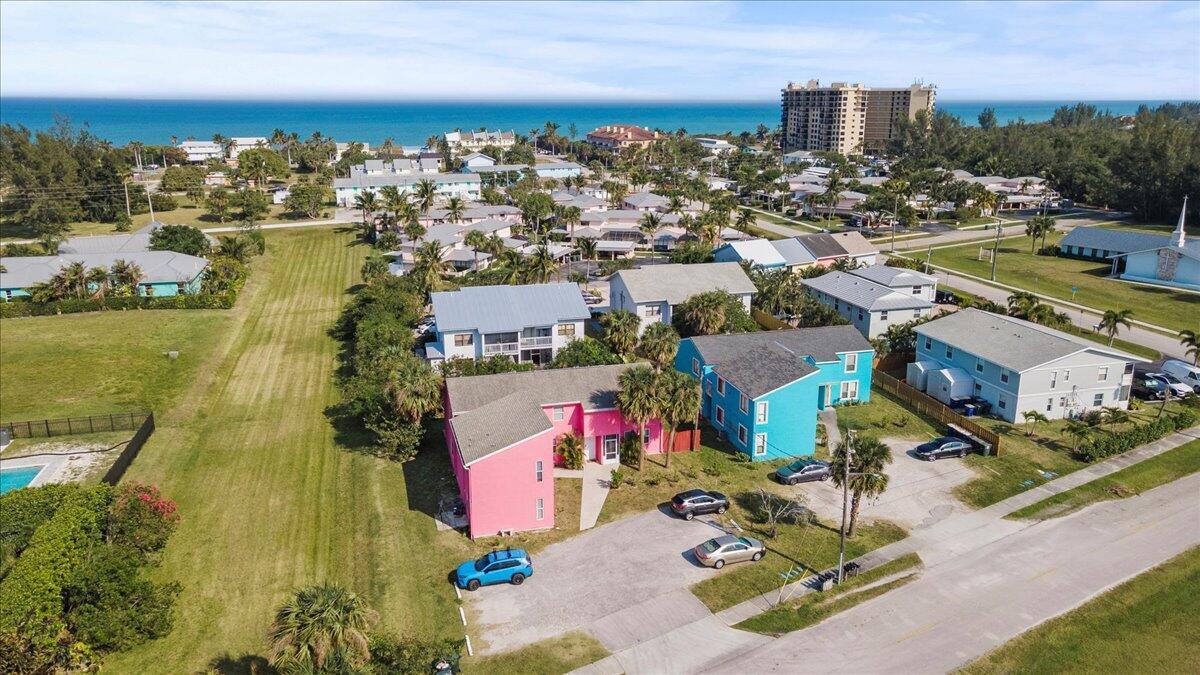 An aerial view shows a pink building and a blue building near a coastal beach — 646 Eldorado Street, Fort Pierce FL 34949, FORT PIERCE, FL